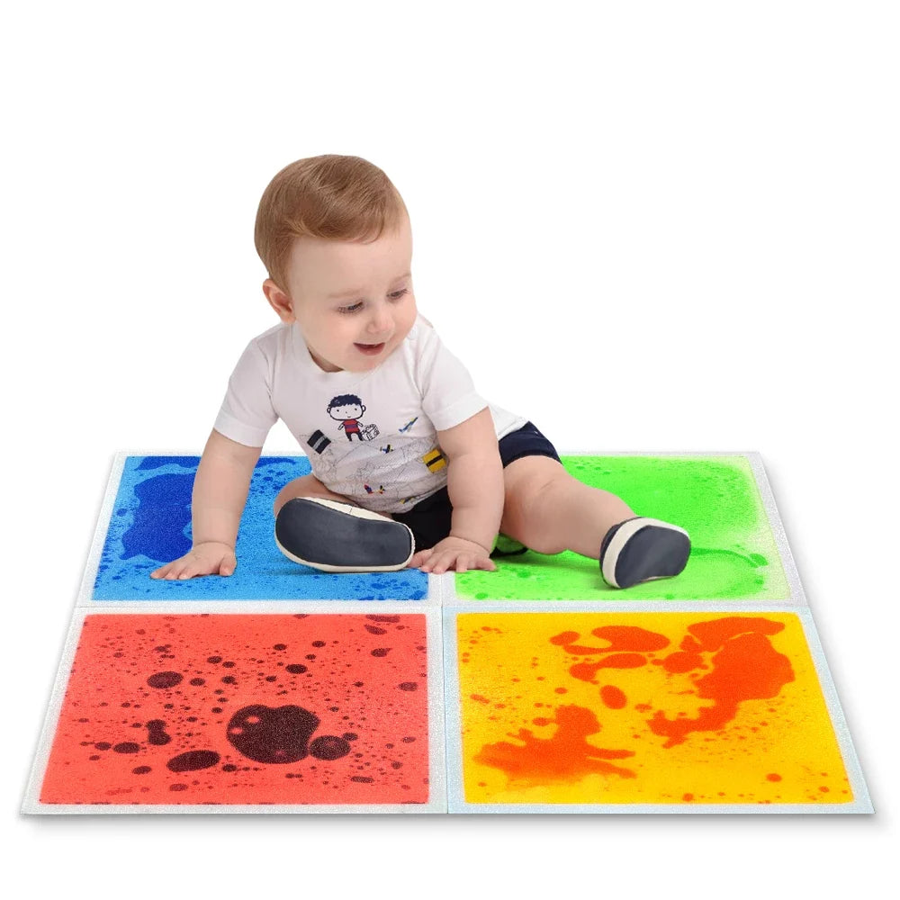 Toddler sitting on colorful liquid sensory floor tiles