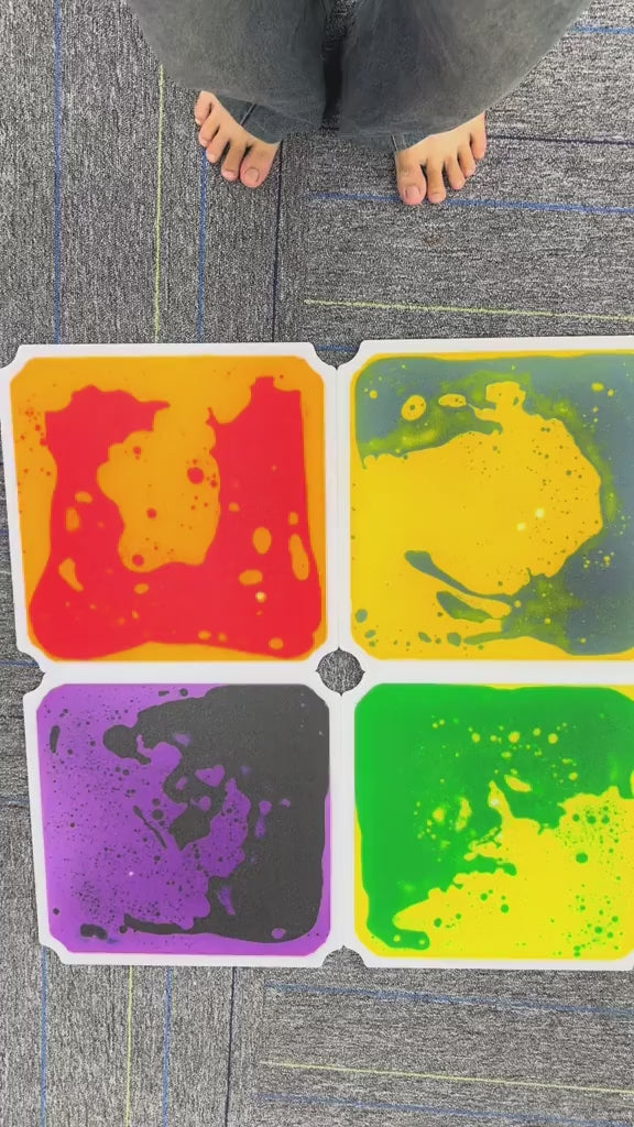 Child barefoot stepping on colorful liquid sensory floor tiles
