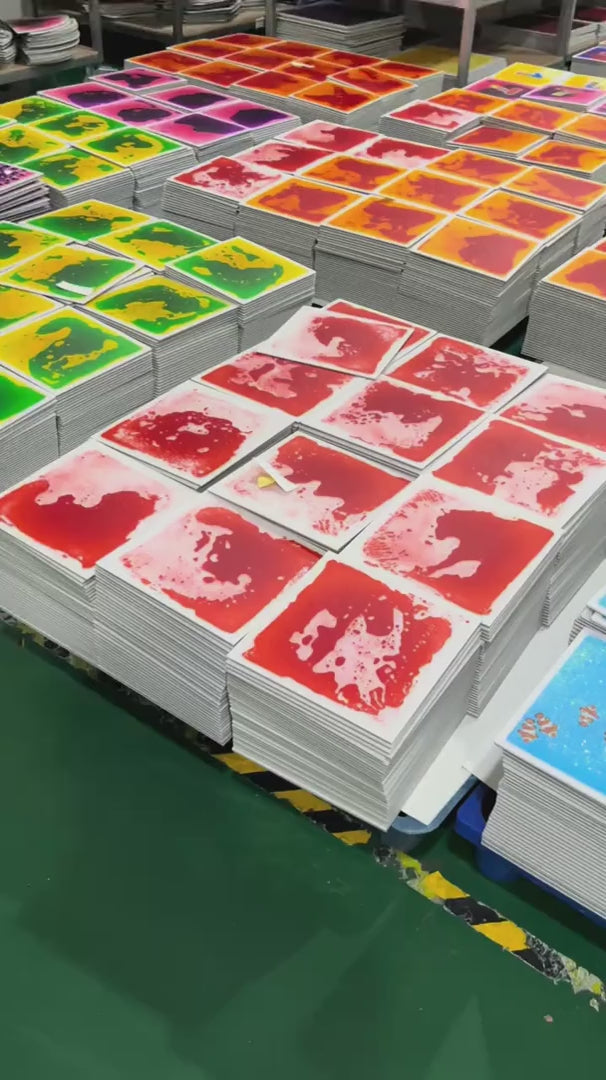 Hand pressing red liquid sensory floor tile